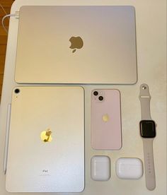 an apple laptop computer sitting on top of a table next to other electronics and accessories