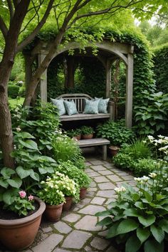 a garden with lots of green plants and flowers on the ground, along with a wooden bench