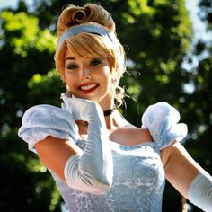 a woman dressed in white is posing for the camera