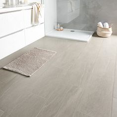 a bathroom with white walls and flooring next to a bathtub in the corner