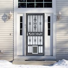 the front door of a house with snow on the ground