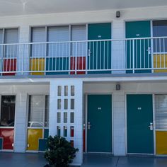 an apartment building with multicolored doors and balconies