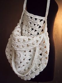 a white crocheted purse on a mannequin