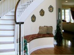 there is a white stair case next to the stairs in this house with decorative wall hangings