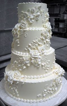 a three tiered wedding cake with white flowers