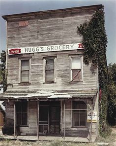 an old run down building with the words hug's grocery on it