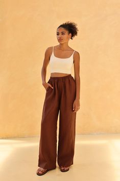 The elastic waist flowy trousers offer comfort with a graceful, effortless style. Handcrafted in our studio to your measurements and preferences, available in over 60 colors. STYLE DETAILS - 100 % linen, medium weight (200gsm), free-shrinkage, amazingly soft feel - Floor length pants; different length is possible - High waisted - Wide-legs - Elastic waistband - Inseam pockets - Pants inseam 29''/73cm and pants outseam 39''/98cm/size S for our lovely model 5ft5/169cm tall. - Leg opening width of Loosely Fitted Linen Harem Pants For Vacation, Vacation Linen Harem Pants With Loosely Fitted Hips, Wide-leg Linen Harem Pants For Beach, Ankle-length Linen Harem Pants For Vacation, Effortless Summer Wide Leg Pants With Elastic Waistband, Brown Wide-leg Vacation Pants, Brown Wide-leg Pants For Vacation, Brown Wide Leg Pants For Vacation, Effortless Wide Leg Linen Pants