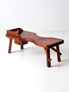 a wooden bench sitting on top of a white floor