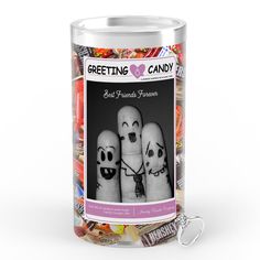 a canister filled with candies and two creepy faces on the front one has a keychain attached to it