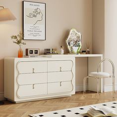 a white dresser sitting next to a lamp on top of a hard wood floor