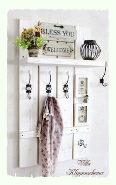 an old door is used as a coat rack