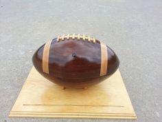 a football sitting on top of a wooden stand