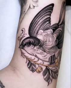 a black and white bird tattoo on the leg