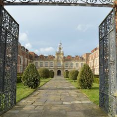 an iron gate leading to a large building