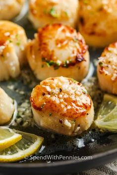 seared scallops with lemon wedges and parmesan cheese