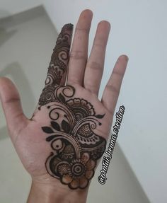 a hand with a henna tattoo on it's palm and the bottom half of its arm