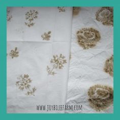 two pieces of white and brown fabric with floral designs on them, sitting next to each other