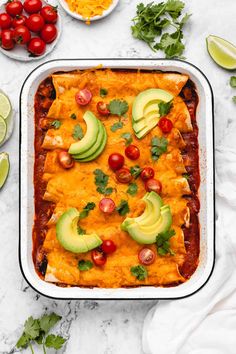 an enchilada casserole with tomatoes, avocado and cheese