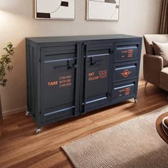 a living room with two pictures on the wall and a blue cabinet in front of it