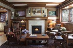 a living room filled with furniture and a fire place in the middle of a room