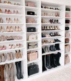 a white closet filled with lots of different types of shoes and purses on shelves