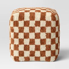 an orange and white checkerboard pattern is shown on the side of a square ottoman