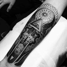 a man's arm with a tattoo on it that has an all seeing triangle