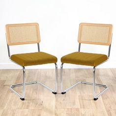 two chairs sitting side by side on top of a hard wood floor next to each other