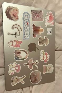 an apple computer with many stickers on it