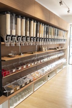 the shelves are filled with many different types of spices and condiments in plastic containers