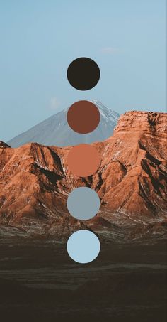 an image of mountains with different colors and shapes in the sky, including three circles