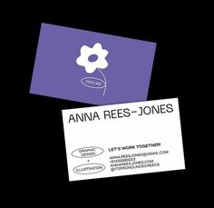 two business cards sitting next to each other on top of a black surface with an image of a flower