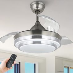 a ceiling fan with two blades attached to it's light fixture in a living room