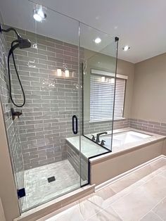 a bathroom with a walk in shower next to a bath tub