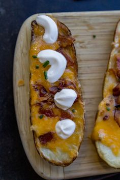 two pieces of bread with cheese and bacon on them