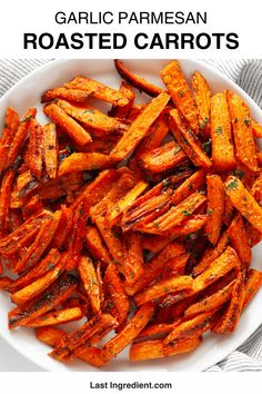 garlic parmesan roasted carrots in a white bowl with text overlay that reads garlic parmesan roasted carrots