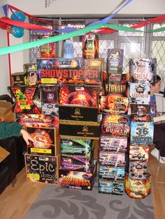 a man standing in front of a pile of dvds