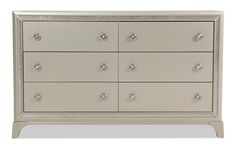 a white dresser with lots of drawers and silver knobs on the front door handles