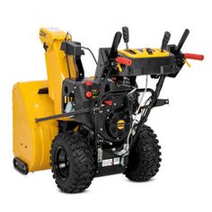 a yellow snow blower sitting on top of a white surface