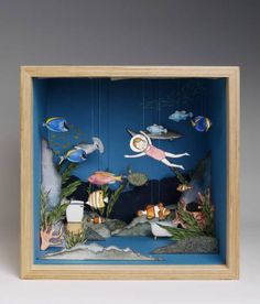 an underwater scene with fish, corals and other marine life in a wooden frame