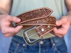 a person holding a belt in their hands