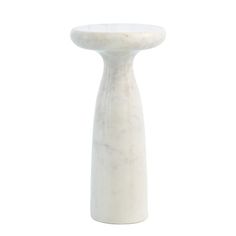 a white marble table with a small round base on the top and one leg in the shape of a vase