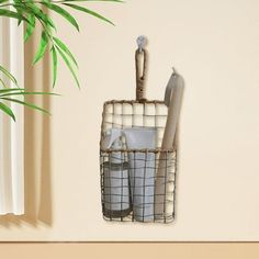 a potted plant sitting on top of a wooden shelf next to a metal basket