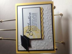 congratulations card with graduation cap and tassels on the front, attached to two metal clothes pins