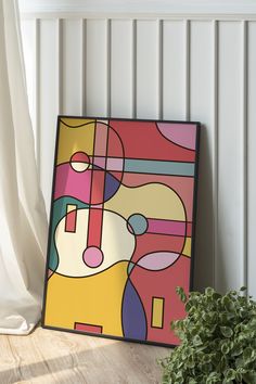 an abstract painting on the wall next to a potted plant in front of it