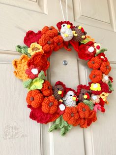 a crocheted turkey wreath hanging on the front door