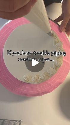 someone is decorating a pink and white cake with icing on the top that says if you have trouble piping most people