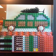 an assortment of sodas and cans stacked on top of each other in a store