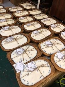 several wooden trays filled with cakes on top of a table covered in white frosting