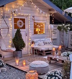 an outdoor living area is lit up with string lights and candles, while the room has a hammock swing